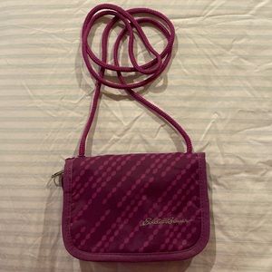 Eddie Bauer travel wallet with long cord to wear crossbody or over-the-shoulder.